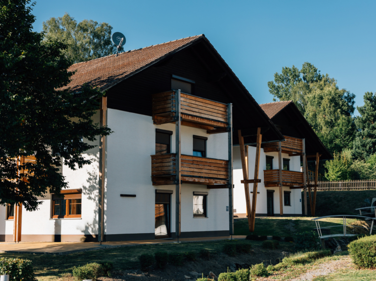 Horizon House: multi-family building with timber balconies and wood-effect windows