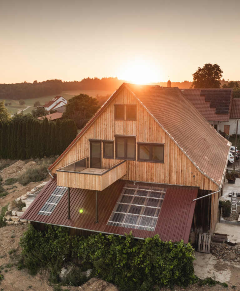 Residence Nova: house with timber cladding and new windows, drone shot at sunset